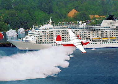 Martin Mars waterbomber dropping beside the cruise ship “The World”